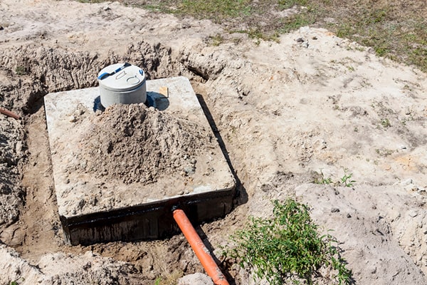 septic tank pumping involves locating the tank, removing the lid, agitating the contents, and pumping out the solid waste